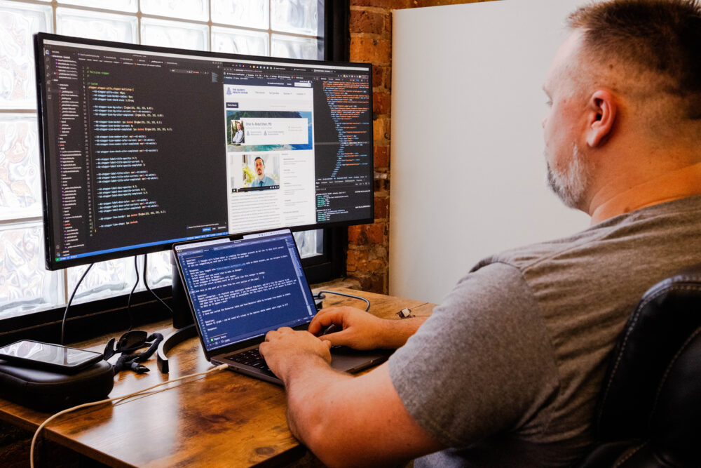 Christopher Brooks coding a website in the Beck Greenville office