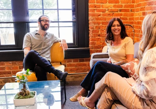 Web developers sitting in a room having a discussion