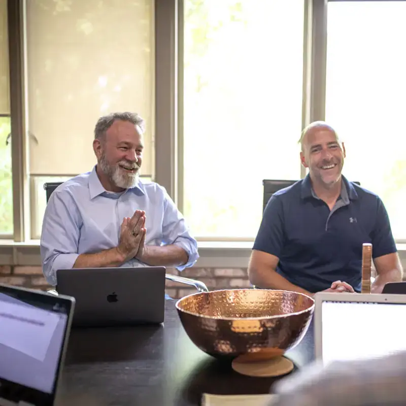 Michael Beck and Ryan Beck at a conference room table